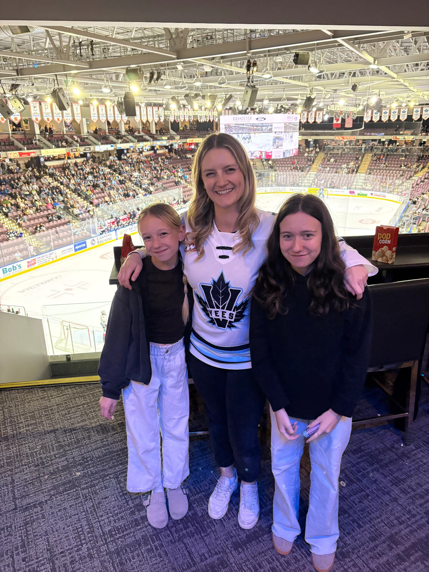 A woman and two girls in the suite overlooking the rink during a Penticton Vees game